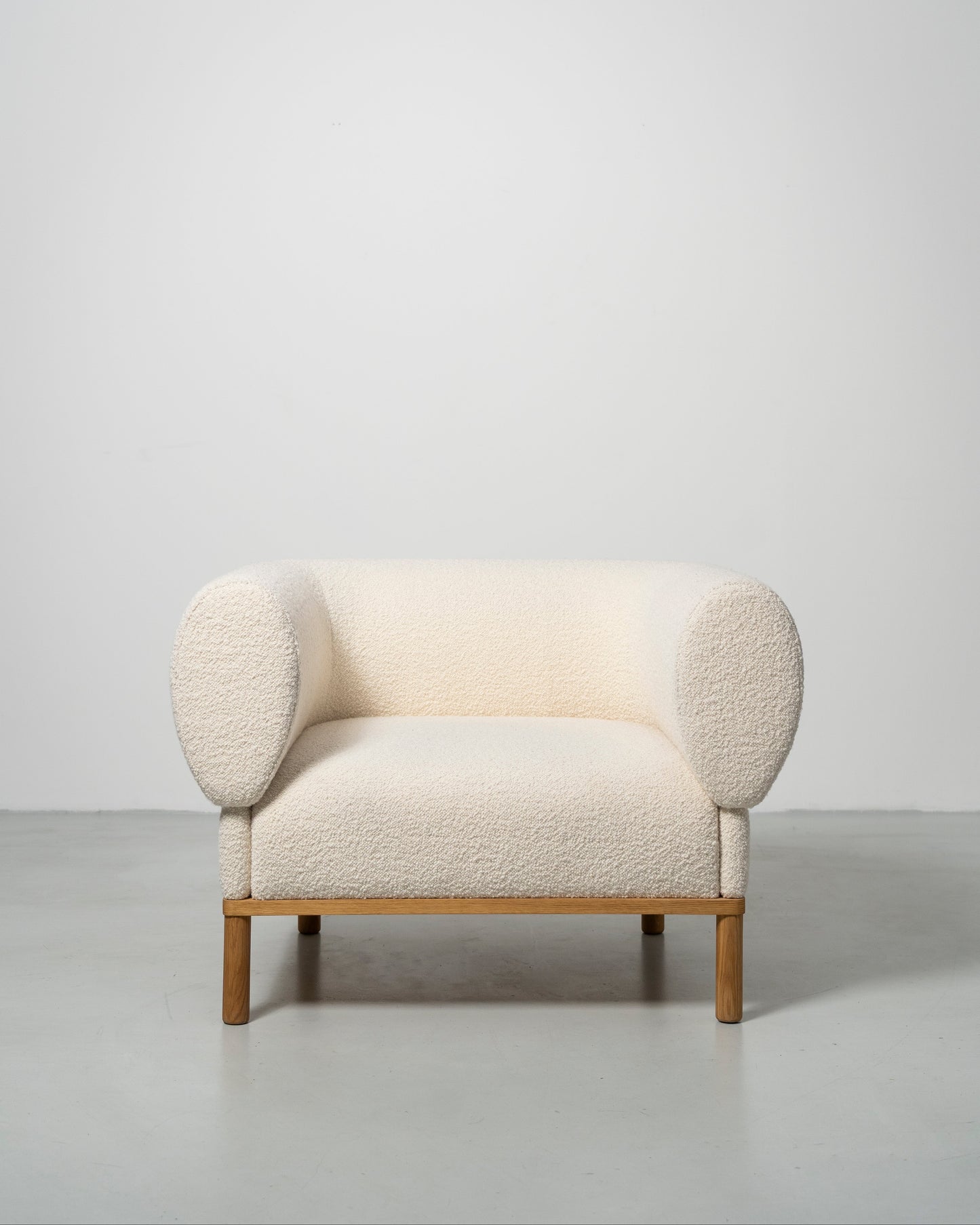 Gallant Chair by Morten & Jonas, contemporary Scandinavian design
white boucle armchair with wooden oak legs 