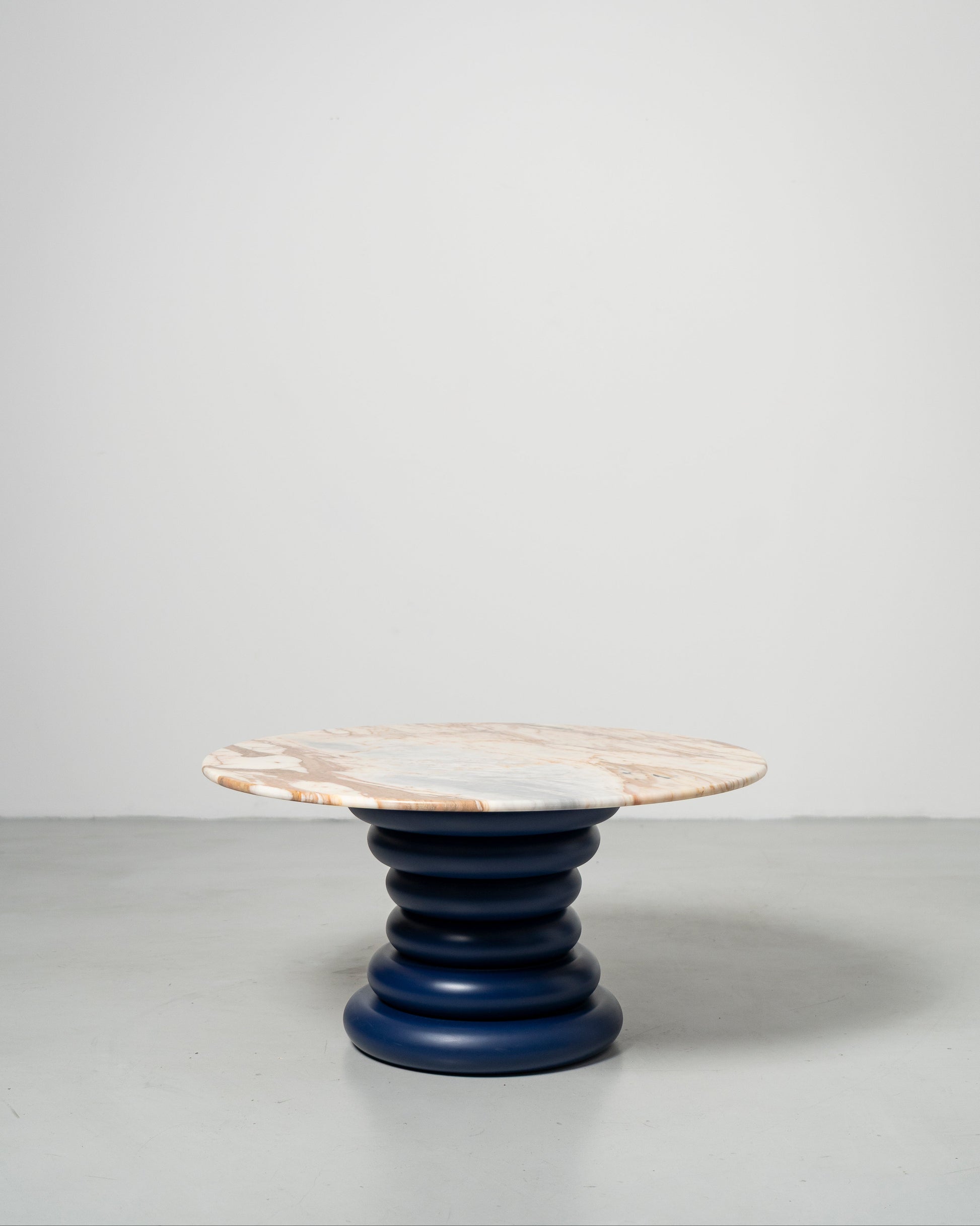 Spine Coffee Table pairs an architectural base of stacked solid-wood rings with a polished stone top, Wooden table with marble top 