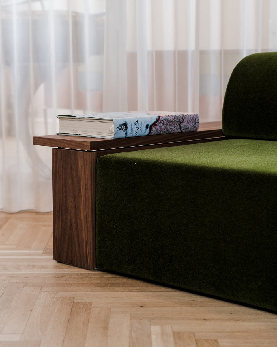 Wittorin Sofa Designed by Caisa Leifsdotter, Scandinavian design A solid-wood base frames a generous seat; movable arm and back cushions support both corner and straight layouts. The wooden surround doubles as a low table surface for lamps, books or a tray.